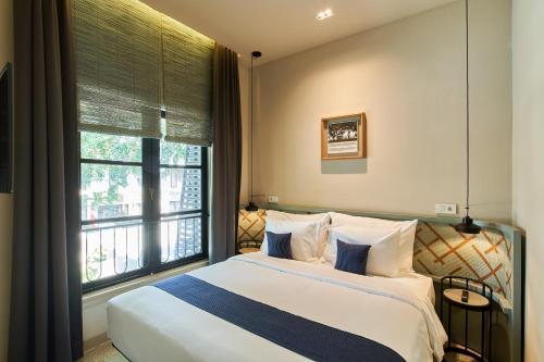 a bedroom with a large bed and a window at Lamandau House in Jakarta