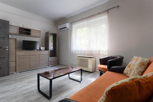 a living room with a couch and a coffee table at Nimród Apartman in Eger