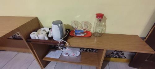 a table with a blender and other items on it at Votel Hotel De'Pratnya Kediri in Kediri