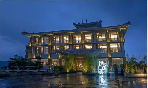 a building with a gate in front of it at night at Hotelday Sun Moon Lake in Yuchi