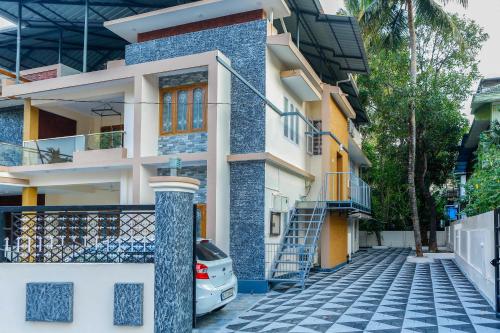 a house with a blue and white facade at Belljem Homes -your own private resort -7 BHK in Trichūr