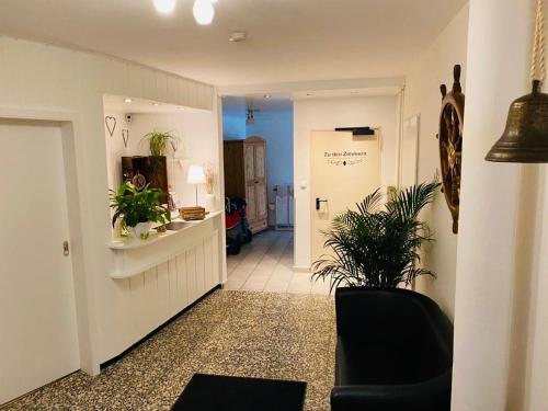 a hallway with a room with plants in it at Hotel Alte Mühle in Elsfleth