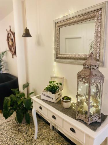 a living room with a mirror and a table with plants at Hotel Alte Mühle in Elsfleth