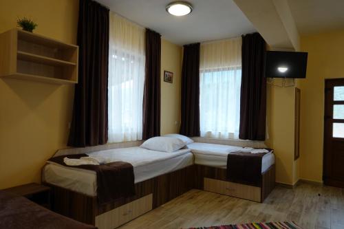 a bedroom with two beds and a window at Борник Хил / Bornik Hill in Devin