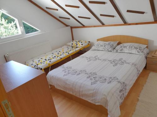 1 dormitorio con cama y banco. en Casa de vacanța Marin en Arpaşu de Sus