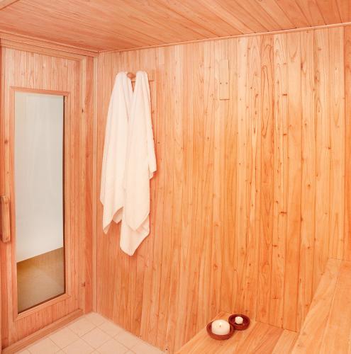 a wooden room with a towel hanging on a wall at Oasis Apart-Spa in Las Gaviotas