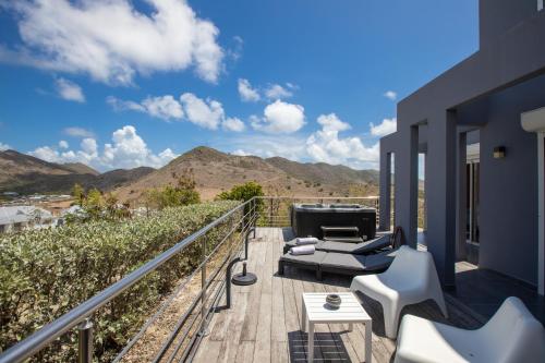 a balcony with a view of the mountains at The Rock in Cul de Sac