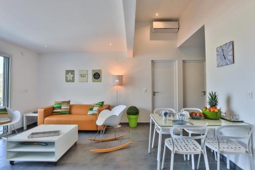 a living room with a couch and a table and chairs at The Rock in Cul de Sac
