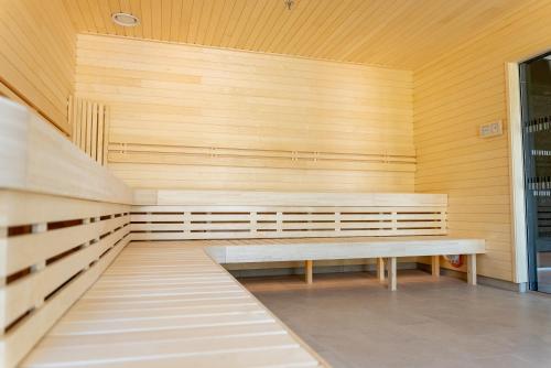 a sauna with a bench in a wooden wall at Clarion Hotel Sundsvall in Sundsvall