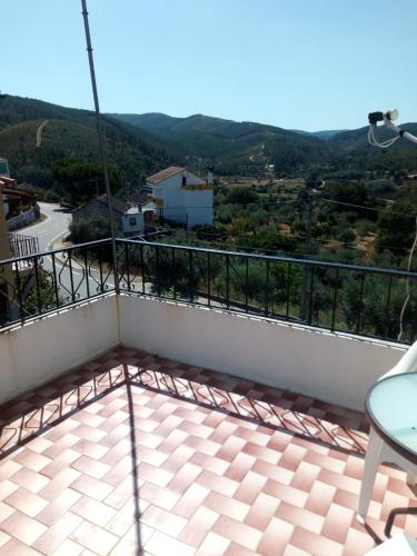 a balcony with a view of the mountains at Casa da fonte in Lavacolhos
