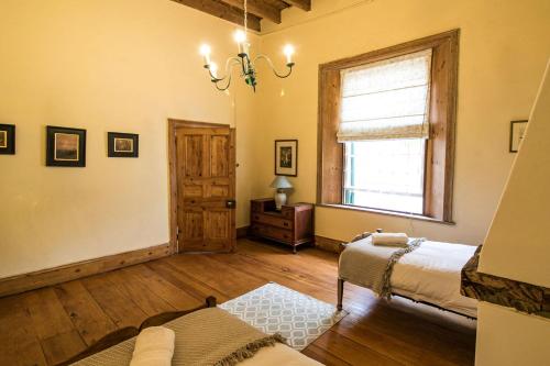 a room with two beds and a window at Garden House in Graaff-Reinet