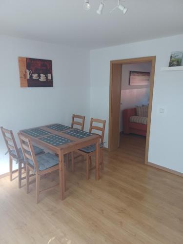 a dining room table and chairs in a room at FeWo s Runde Wiese RW in Greifswald