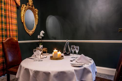 a table with a candle on top of it at Melville Castle Hotel in Edinburgh