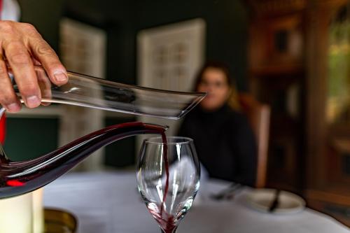 a person pouring wine into a wine glass at Melville Castle Hotel in Edinburgh