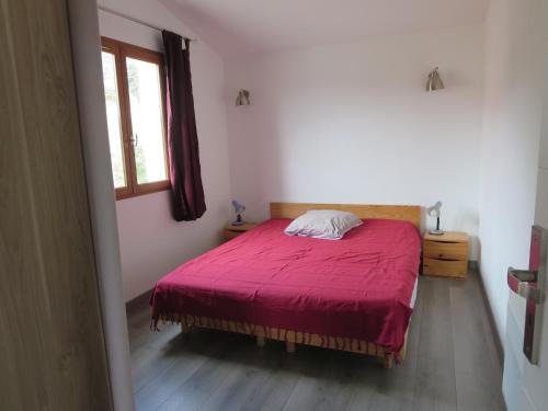 - une chambre avec un lit rouge et une fenêtre dans l'établissement 2P entre mer et montagne, à Gattières