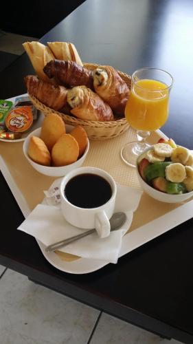 a breakfast tray with a cup of coffee and pastries at Budget Hotel Melun Sud - Dammarie Les Lys in Dammarie-lès-Lys