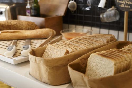 a group of breads on a counter in a kitchen at Petit Palace Ruzafa in Valencia