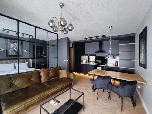 a living room with a couch and a table at Silesia Aparthotel in Szczecin