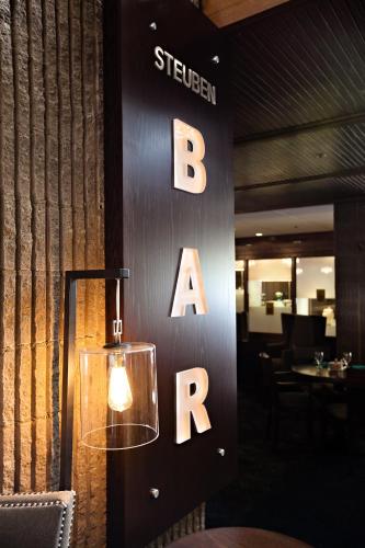 a sign for a restaurant with a sign for a bar at Radisson Hotel Corning in Corning