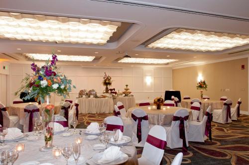 a banquet hall with round tables and chairs at Radisson Hotel Corning in Corning