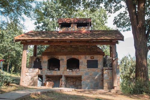 a stone oven with a roof on top of it at Садиба У Романа 'двохрівневий номер' in Verkhneye Sinevidnoye