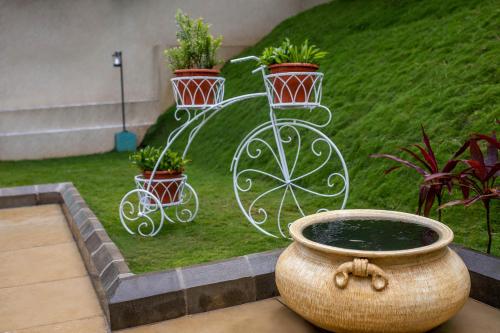 a planter with a bike with plants in it at Tuskers Hill by Poppys Anaikatti in Palghat
