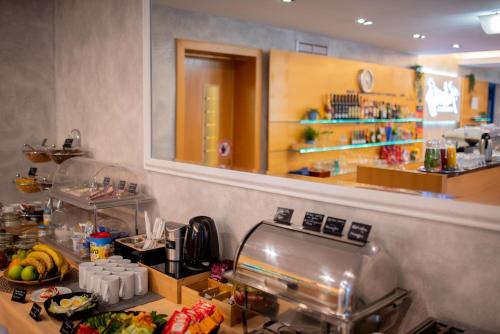 a kitchen with a counter with food on it at Felicity Garni Hotel in Bratislava