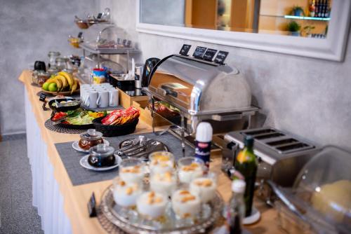 a kitchen counter with food on a counter top at Felicity Garni Hotel in Bratislava