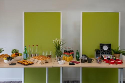 a table with a bunch of fruits and drinks on it at ibis Pontorson Baie Du Mont Saint Michel in Saint-Georges-de-Gréhaigne