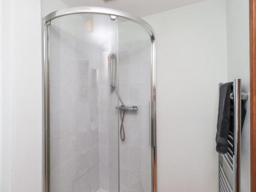 a shower with a glass door in a bathroom at Solway Firth View in Annan