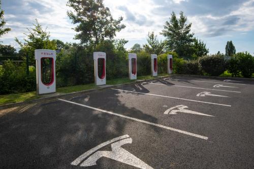 a row of portable toilets in a parking lot at ibis Pontorson Baie Du Mont Saint Michel in Saint-Georges-de-Gréhaigne