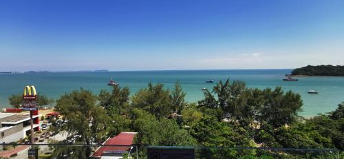 a view of a beach with boats in the water at Dwharf Seaview Executive Suit PortDickson in Port Dickson