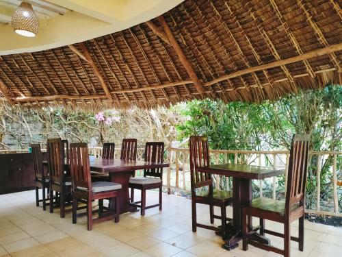 a dining room with a table and chairs at Upani in Diani in Diani Beach