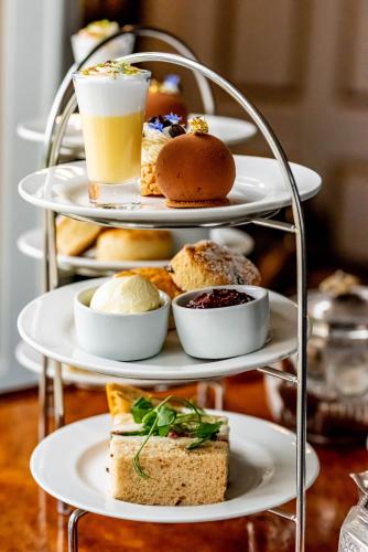 a three tiered tray filled with different types of food at Melville Castle Hotel in Edinburgh