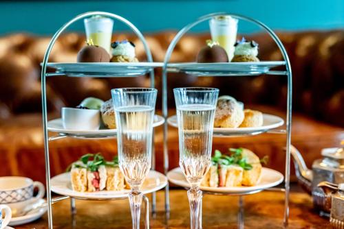 a table with three plates of food and glasses of water at Melville Castle Hotel in Edinburgh