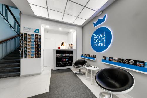 a shop with two stools and a sign that reads royal court hotel at Royal Court Hotel in Prague