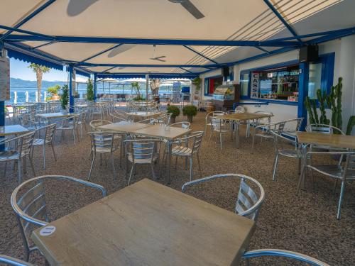 an empty restaurant with tables and chairs under a tent at Parc Hotel Gritti in Bardolino