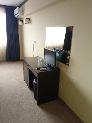 a desk with a computer on it in a room at Park Hotel Stratesh in Lovech