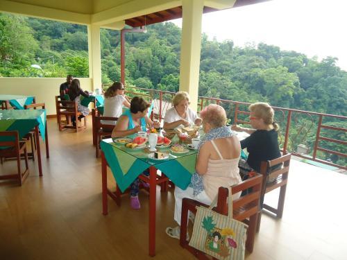 a group of people sitting at a table eating food at Nature Walk Resort in Kandy