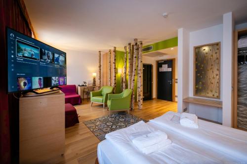 a hotel room with a bed and a flat screen tv at Boutique Exclusive B&B in Trento