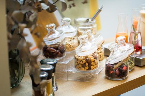 a table with several glass jars filled with food at ICON Malabar in Málaga