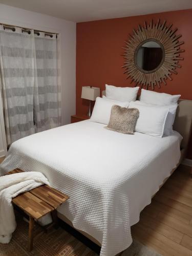 a bedroom with a large white bed and a mirror at Water View Home in Seattle