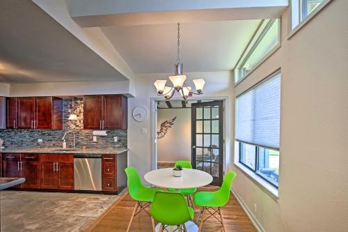 a kitchen with a table and green chairs at Bright and Modern Texas Getaway - 7 Mi to The Alamo! in San Antonio