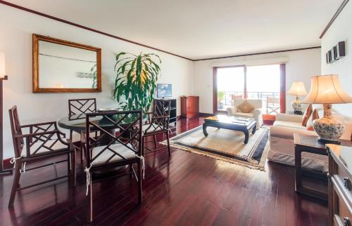 a living room with a table and chairs at Saigon Domaine Luxury Residences in Ho Chi Minh City