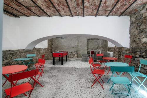 a room with tables and chairs and a piano at Spazio 77 - The House Of Travelers in Como