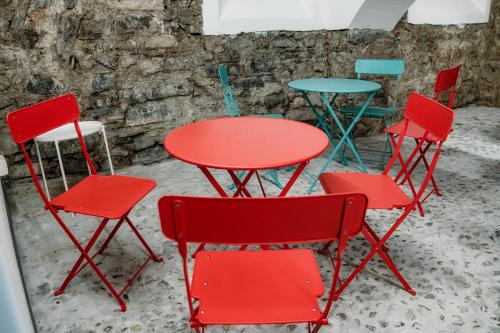 a group of red chairs and a red table and chairs at Spazio 77 - The House Of Travelers in Como