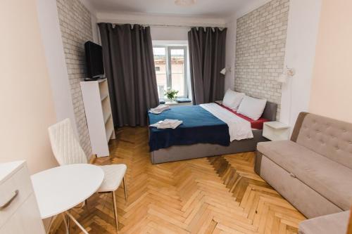 a small room with a bed and a couch at Mary in Lviv