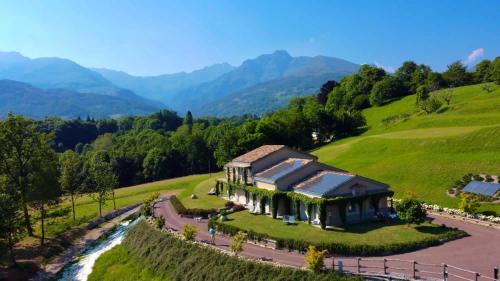 a house on a hill next to a river at CASCINA SERRA ECO-HOUSE beb in Muzzano
