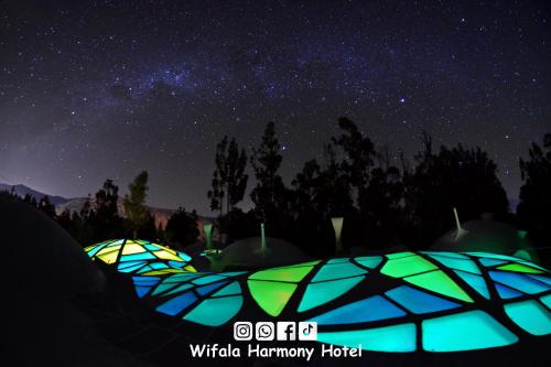 a group of umbrellas at night under the stars at Wifala Harmony Hotel in Urubamba