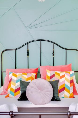 a bed with a bunch of pillows and a large pillow at À da Avó -The Guesthouse in Faro